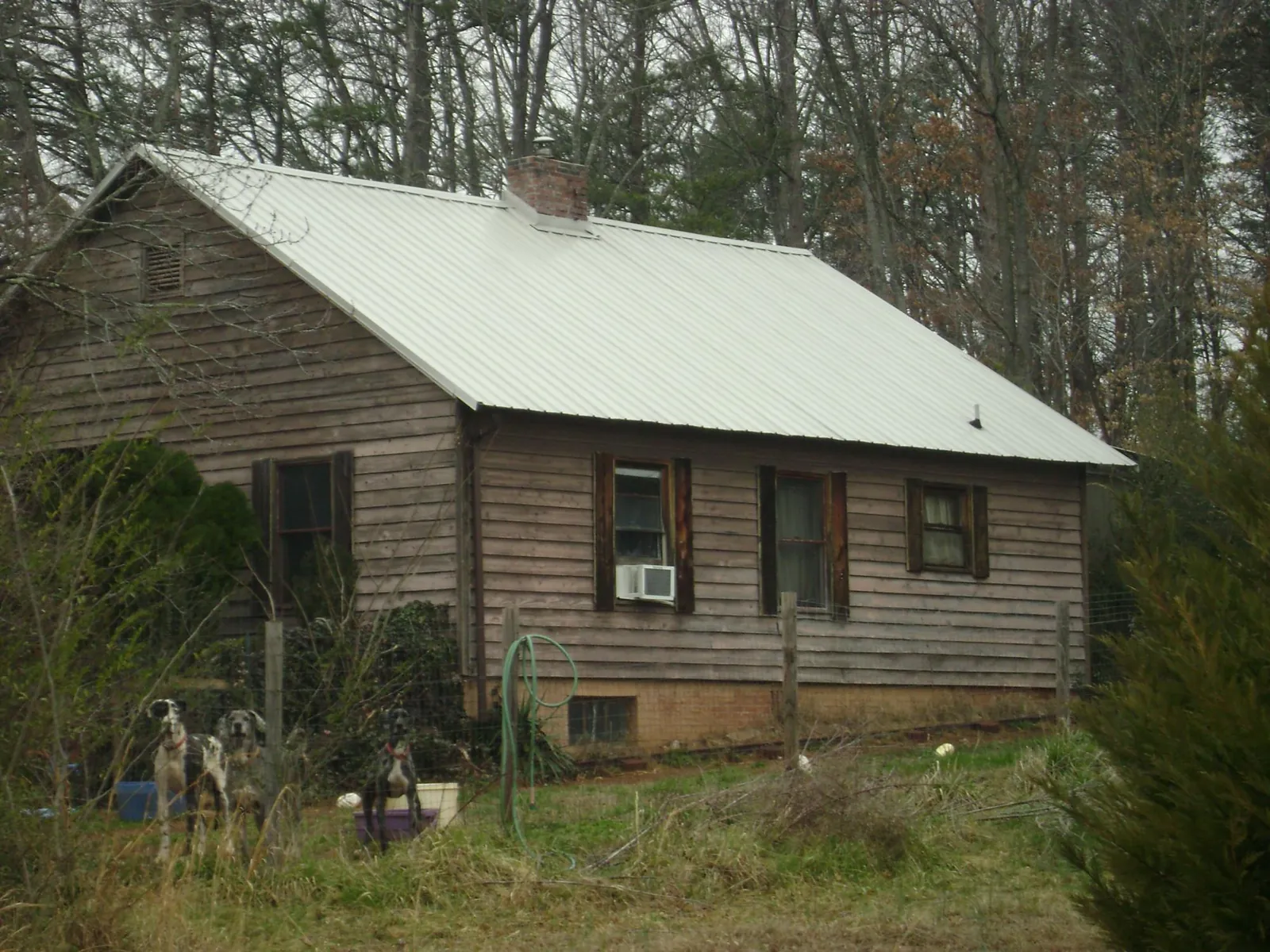 White metal roof on an old wood sided farmhouse, from a Metal Roof Installation job in Luthersville